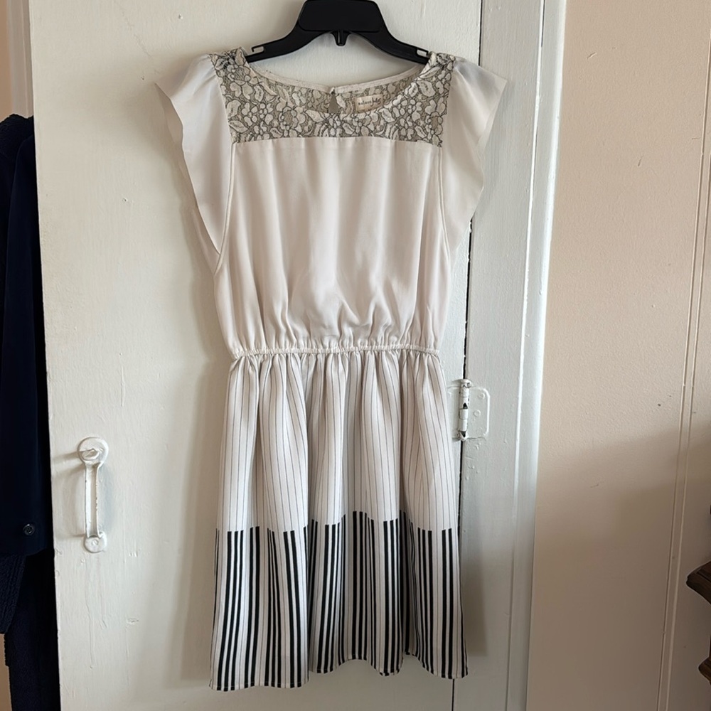 Adorable ivory dress with piano key skirt